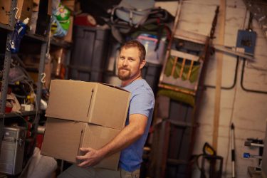 man with boxes in garage